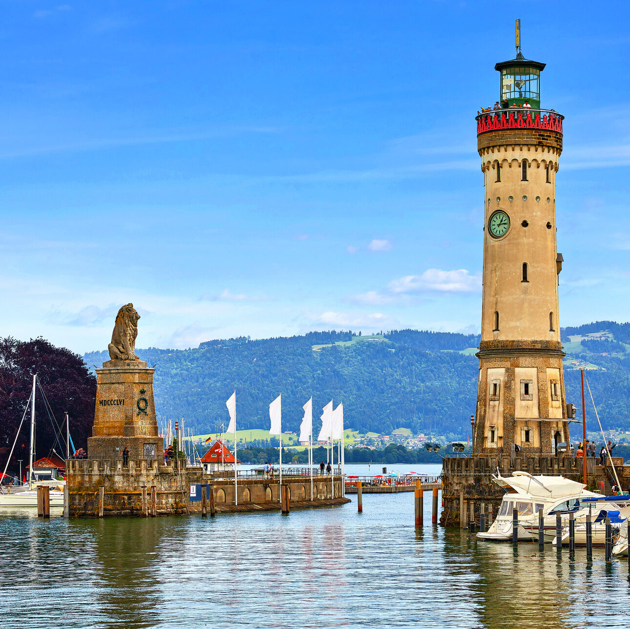 Lindau, Germany. Old lighthouse with clock in bay. Antique bavar